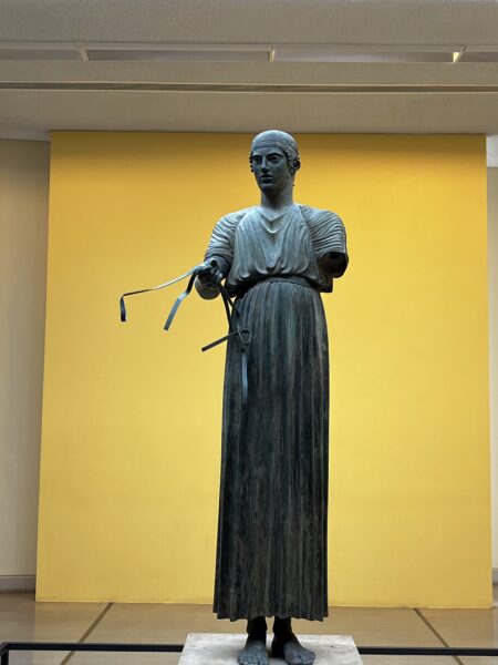 A picture of a bronze statue at the Delphi Museum.
