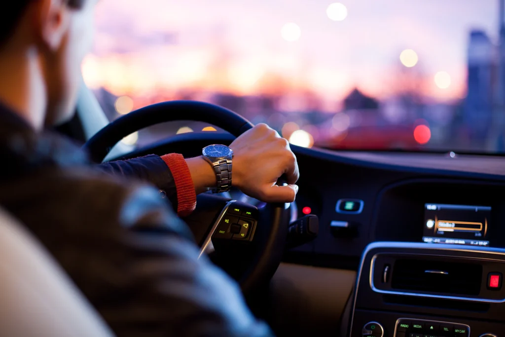 Private driver with hands on the steering wheel